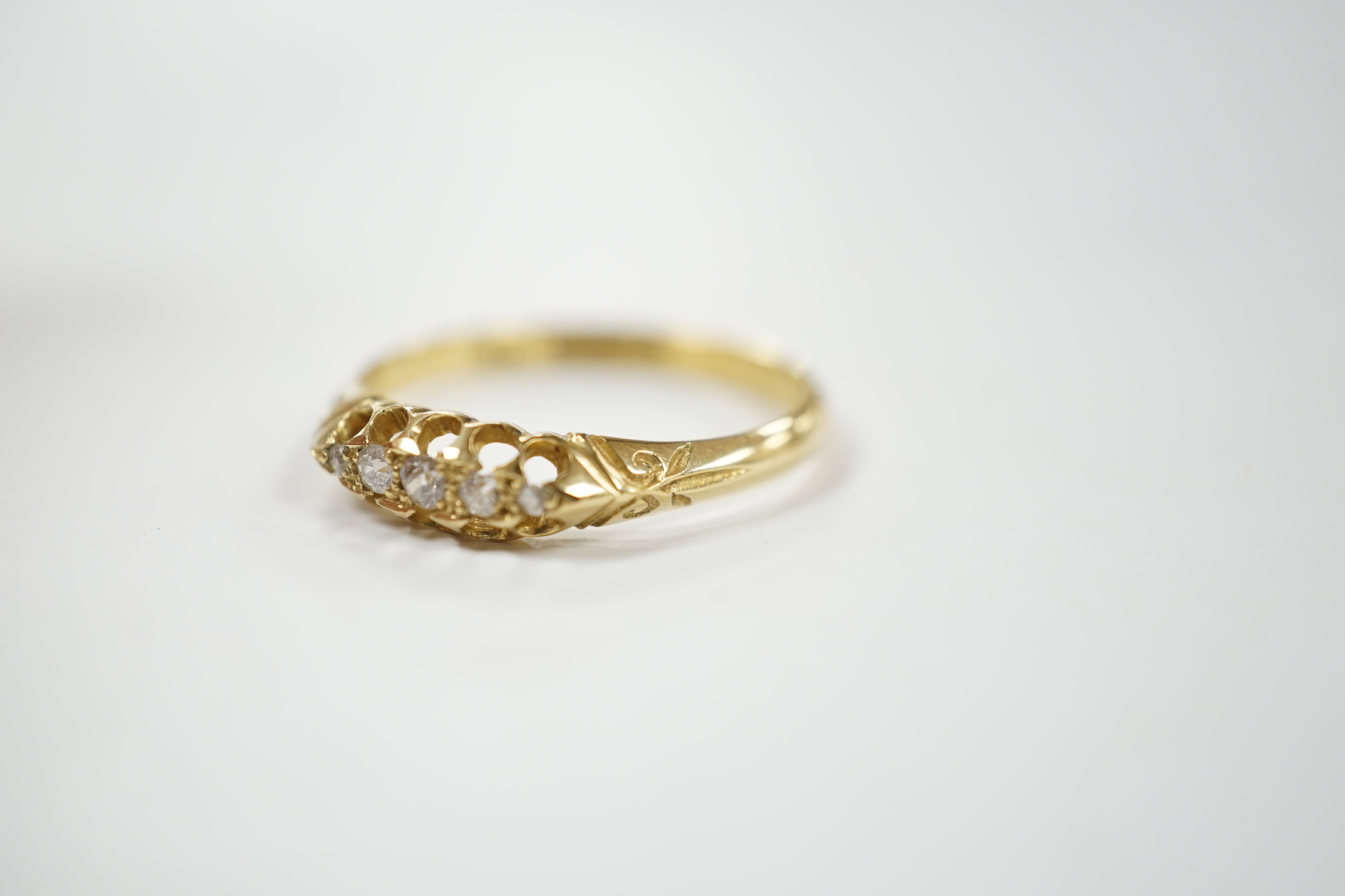 A Victorian 18ct gold and graduated five stone diamond chip set half hoop ring, size X, gross weight 3.6 grams.